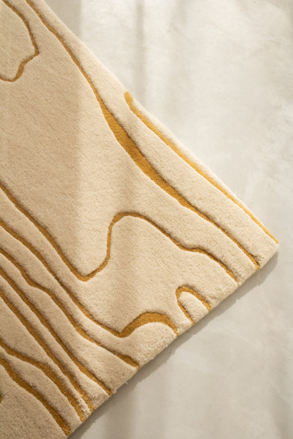 ETTORE wool rug corner detail showing carved wood vein contours