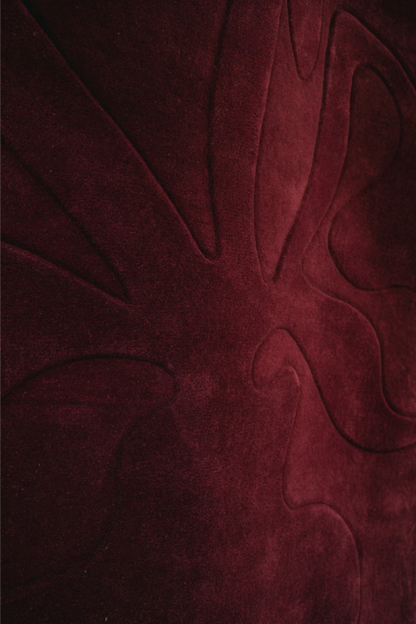 Close-up of a textured red fabric with floral patterns