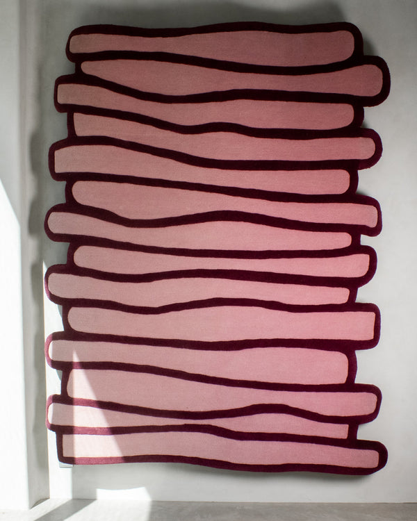 LAYERED wool rug with stacked organic pattern in soft pink and burgundy tones – full view