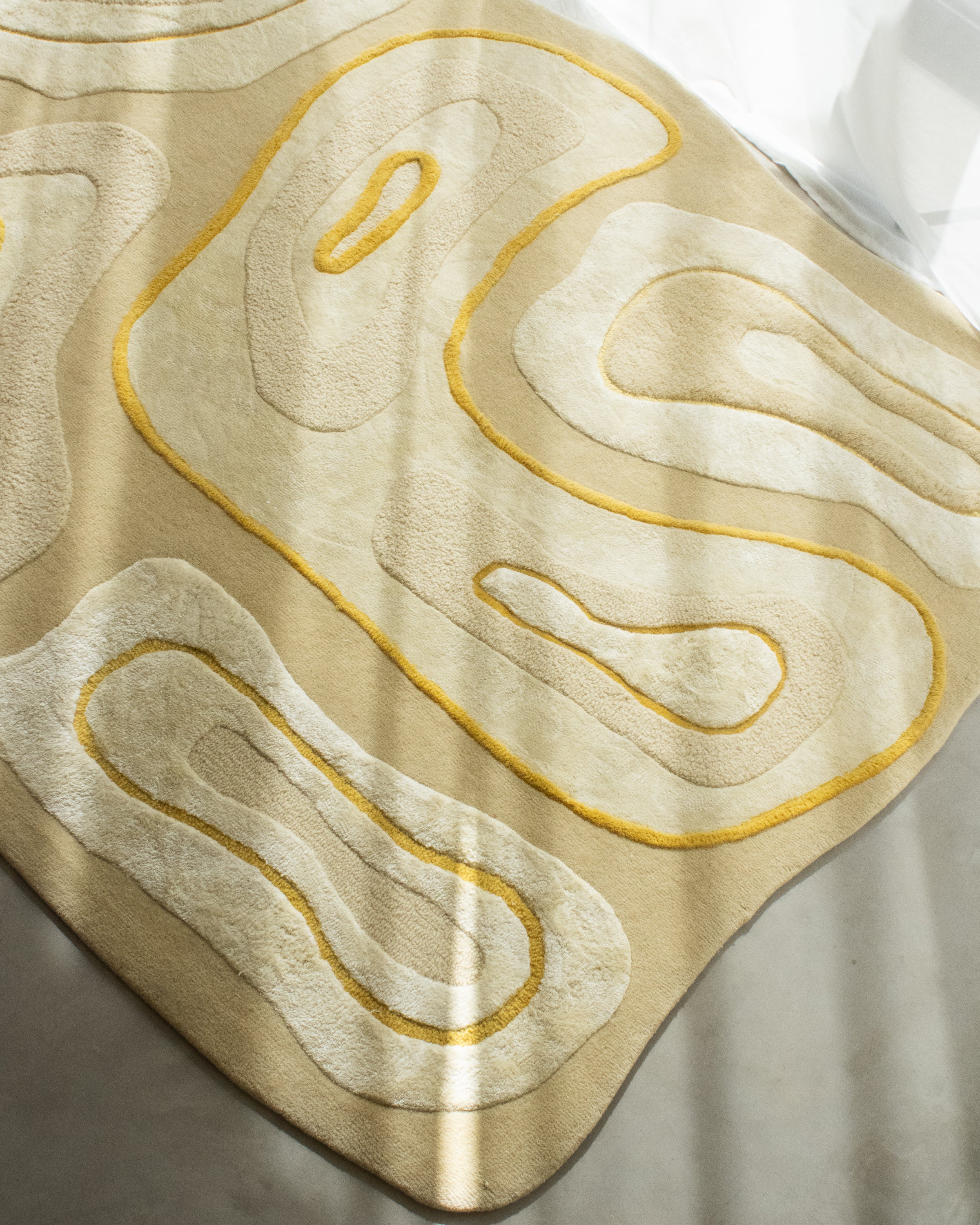 TEXTURED wool rug with raised organic shapes and yellow accents