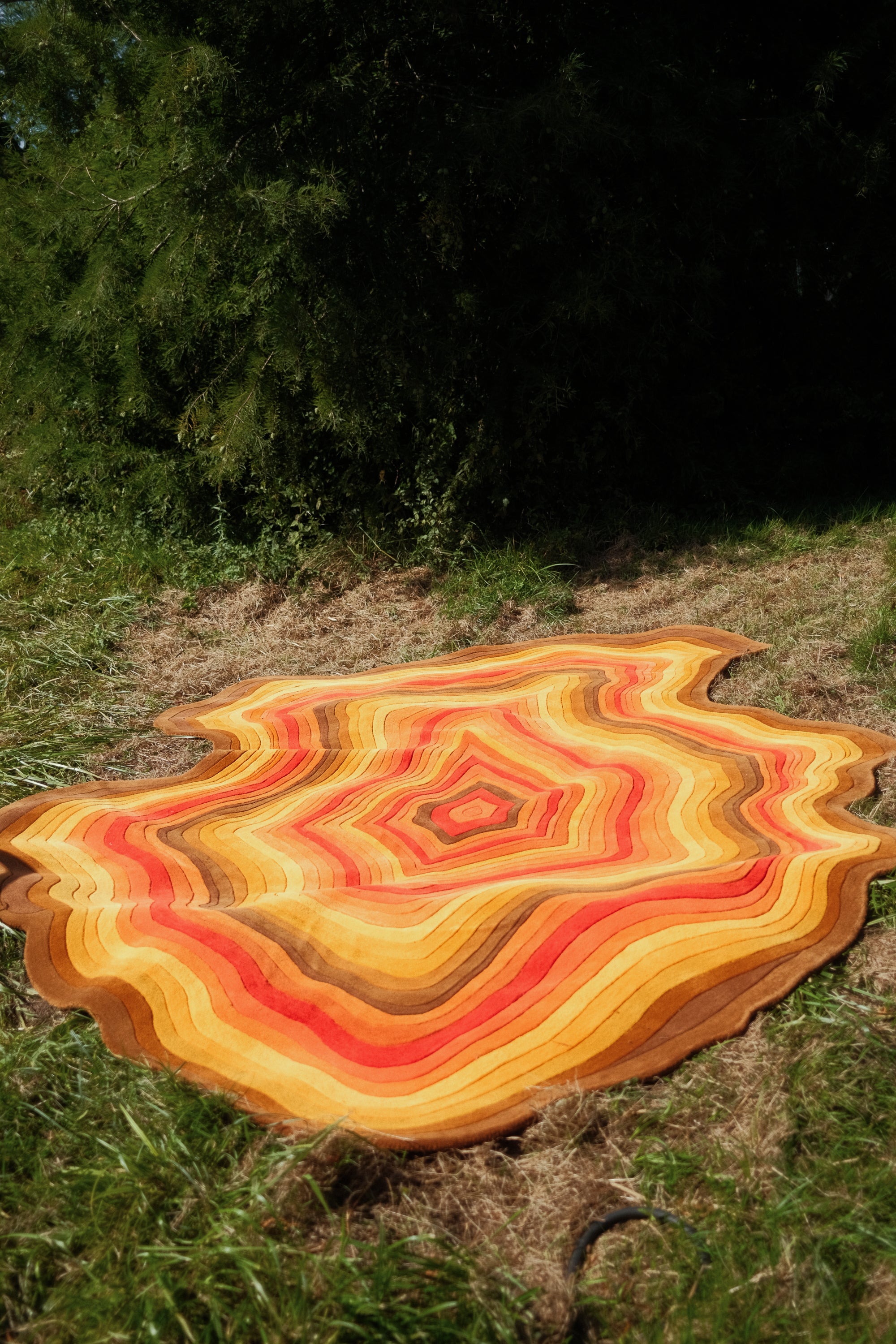 The Crystal designer rug with layered crystal pattern in orange and red tones – full view